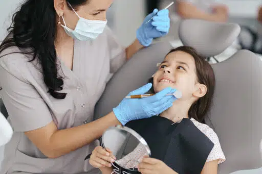 female dentist taking care of a girl patient