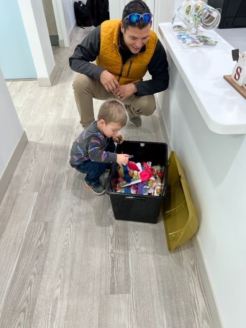 Pediatric patient playing in toy box at Front Row Pediatric Dentistry lobby.