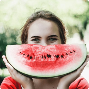 girl holding up watermelon